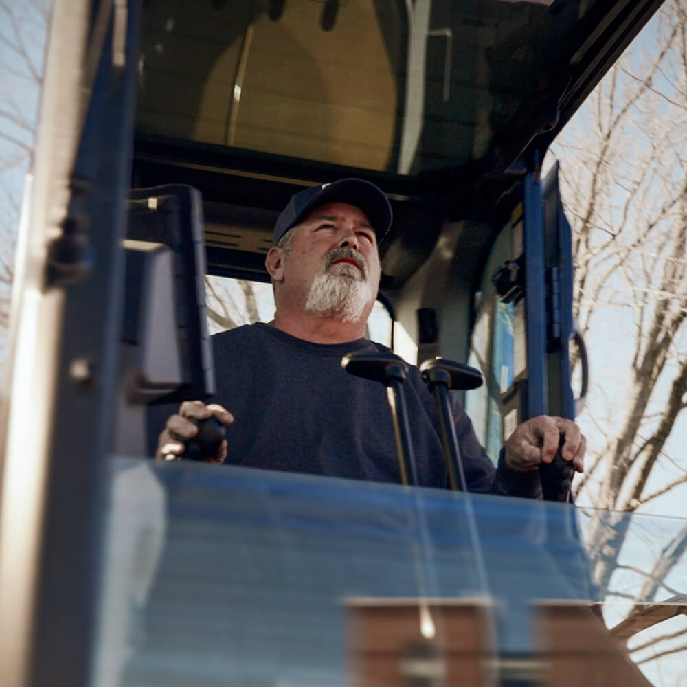 Chad operating an excavator for Cutting Edge Construction & Excavation in Ann Arbor, Michigan