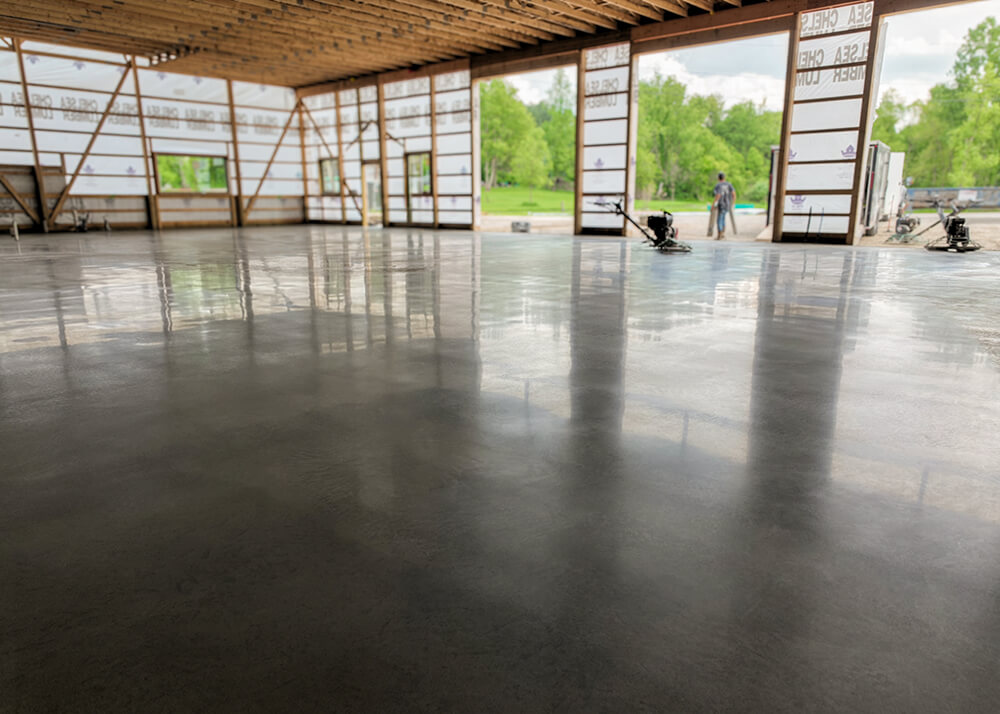 Large concrete flatwork slab finished inside pole barn building by Cutting Edge Construction in Dexter Michigan