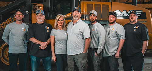 Cutting Edge Construction and Excavation team standing in front of heavy equipment in Michigan
