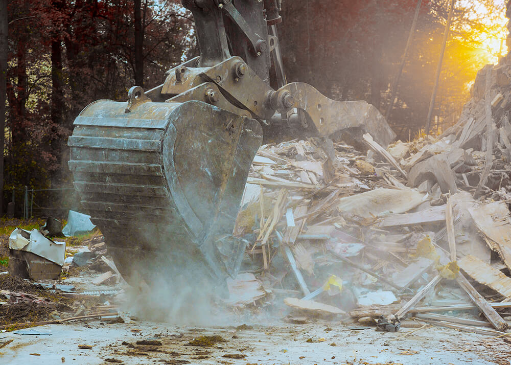Excavation crew removing demolition debris and clearing construction site in Southeast Michigan