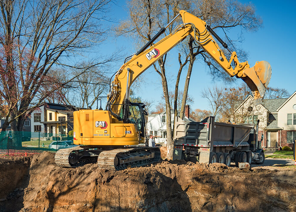 CAT 325 excavator digging a basement for residential construction by Cutting Edge Construction & Excavation
