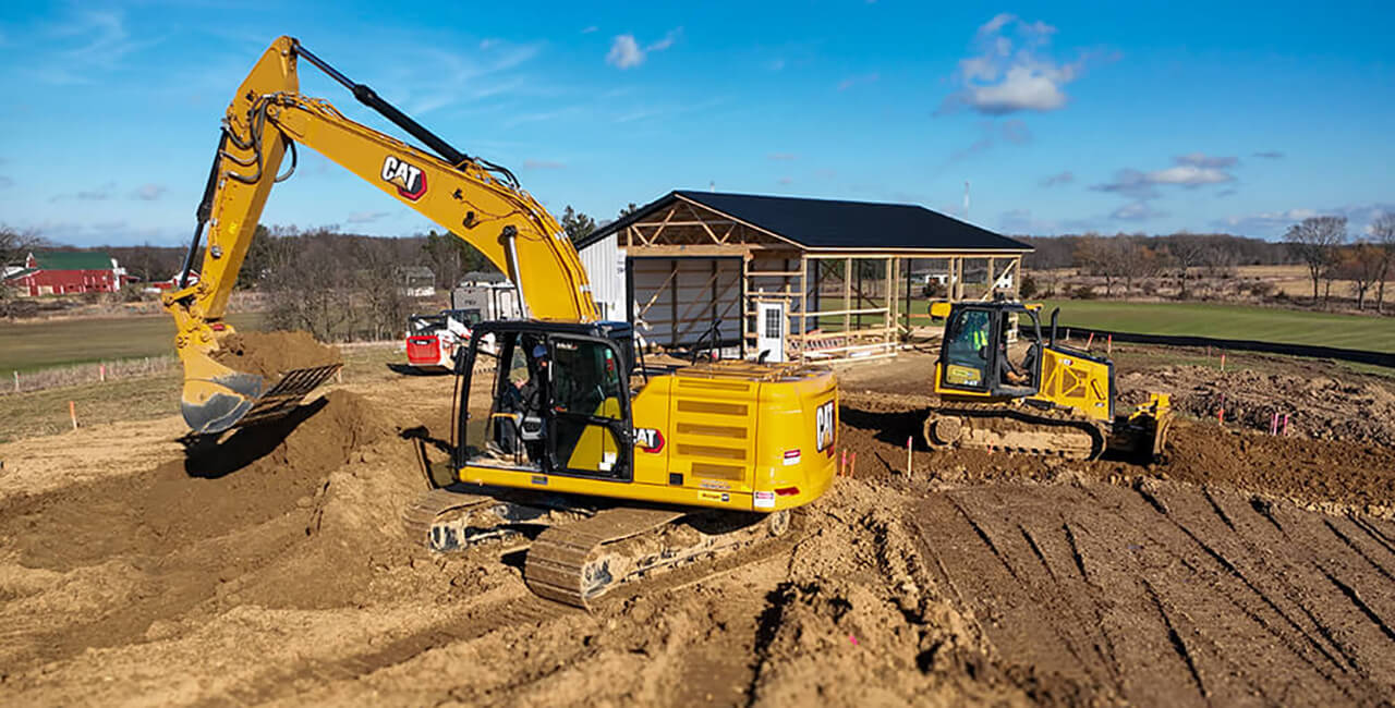 Excavation and grading work for pole barn site preparation using heavy equipment before concrete installation
